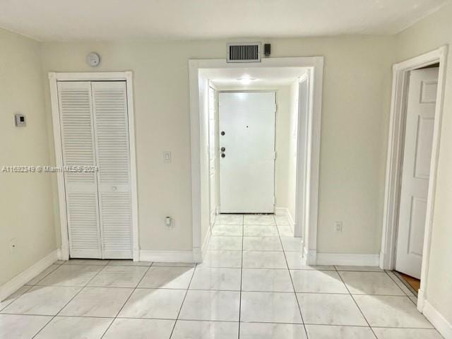 hallway featuring light tile patterned floors