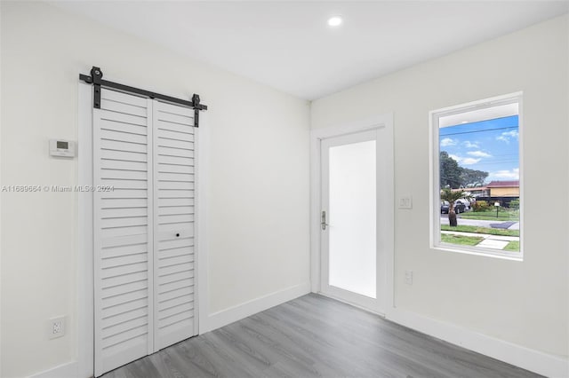 interior space featuring a barn door and hardwood / wood-style flooring