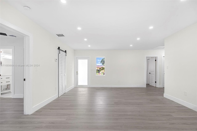 entryway with light wood-type flooring and a barn door