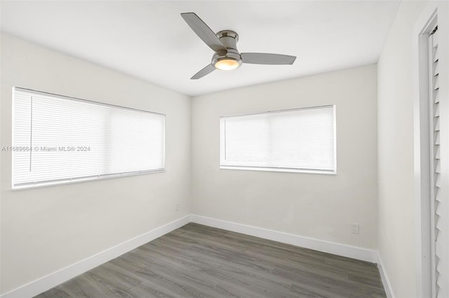 unfurnished room featuring dark hardwood / wood-style floors and ceiling fan