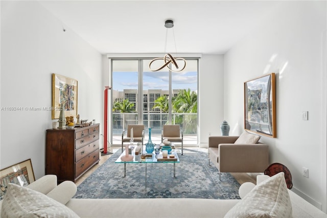 living room with floor to ceiling windows and an inviting chandelier