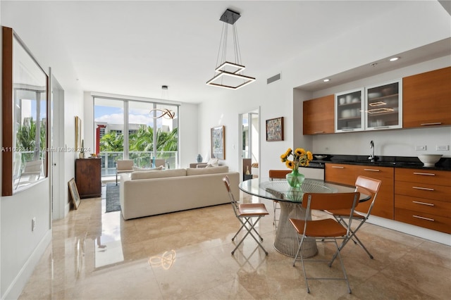 dining space featuring a wall of windows and sink