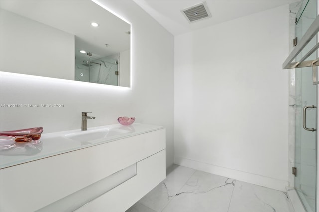 bathroom featuring vanity and an enclosed shower