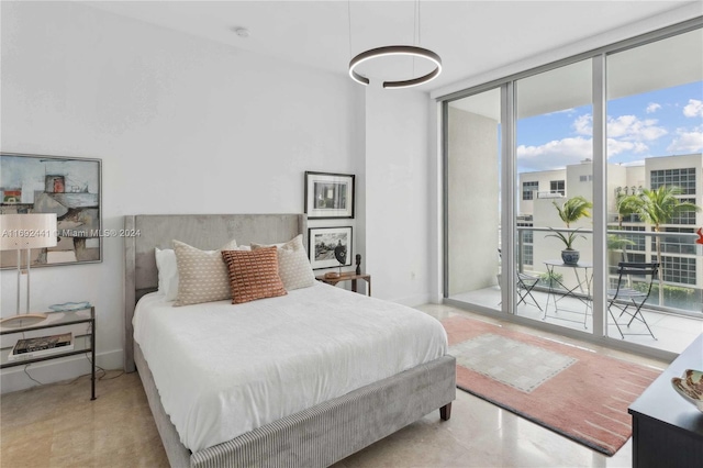 bedroom featuring access to exterior, multiple windows, and expansive windows