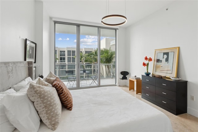 bedroom with access to exterior and a wall of windows