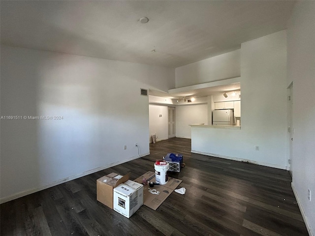 unfurnished living room featuring dark wood-type flooring