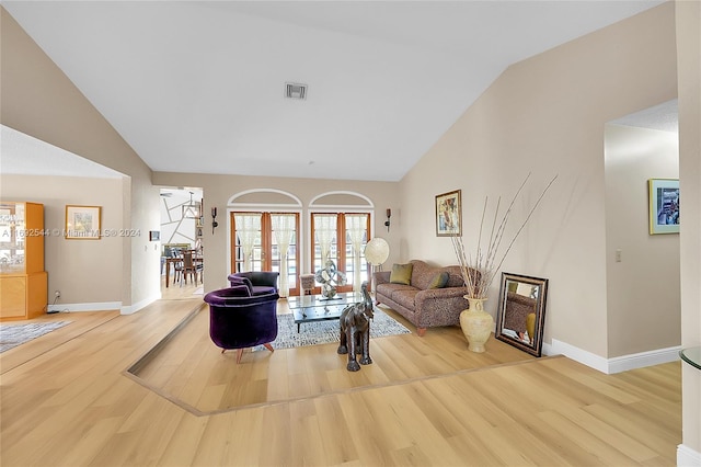 living room with vaulted ceiling and light hardwood / wood-style flooring