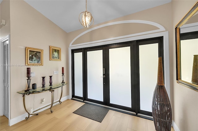 entrance foyer featuring light hardwood / wood-style floors and vaulted ceiling