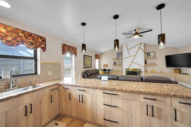 kitchen featuring light hardwood / wood-style floors, hanging light fixtures, sink, ceiling fan, and light brown cabinetry