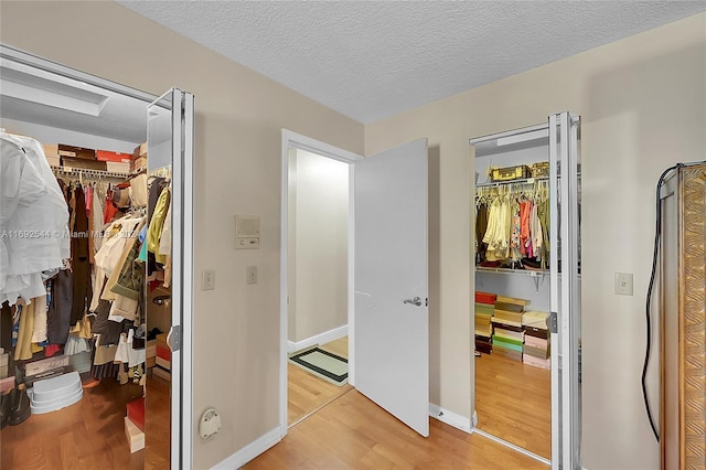 bedroom with wood-type flooring and a textured ceiling