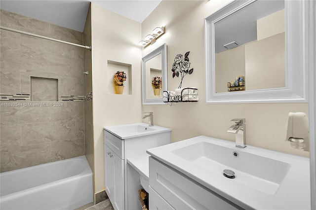 bathroom with vanity and tiled shower / bath