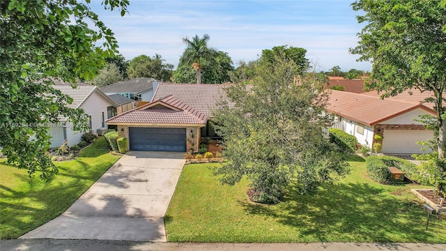 view of front of house with a garage and a front yard