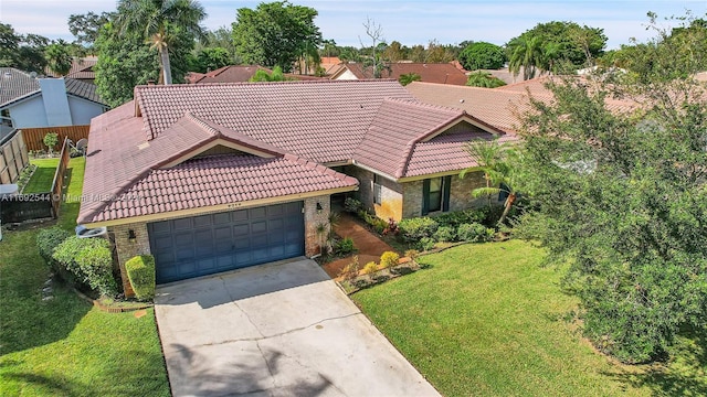 view of front of property featuring a garage and a front lawn