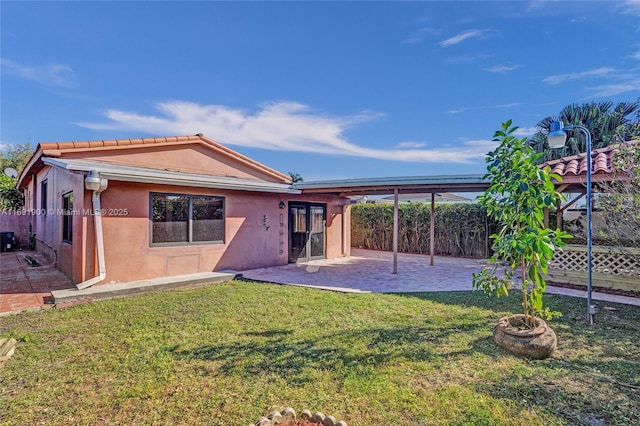 back of house featuring a yard and a patio