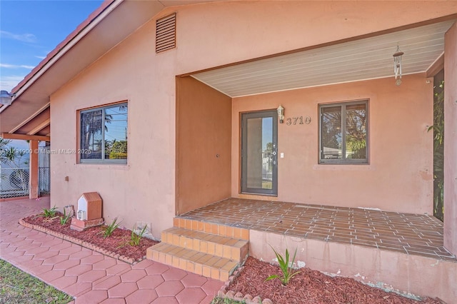 doorway to property featuring a patio area