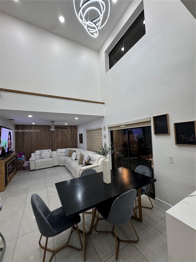 interior space with a high ceiling, an inviting chandelier, and light tile patterned floors