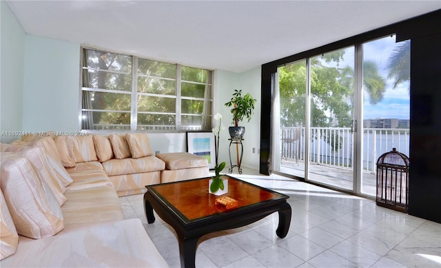 living room with a water view and a wall of windows