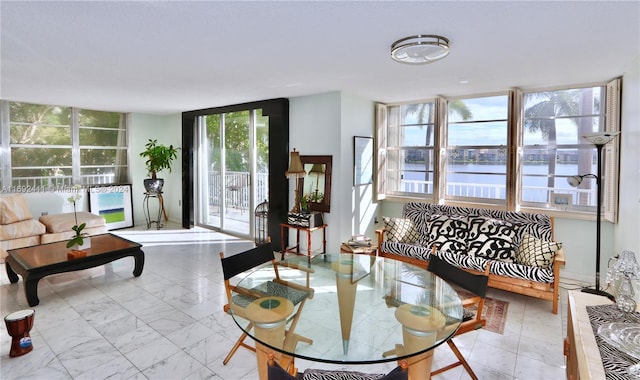 living room with a water view and a wall of windows