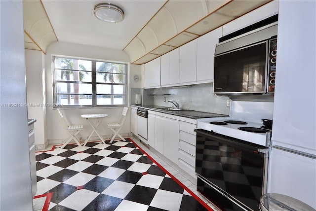 kitchen with decorative backsplash, white cabinetry, white appliances, and sink