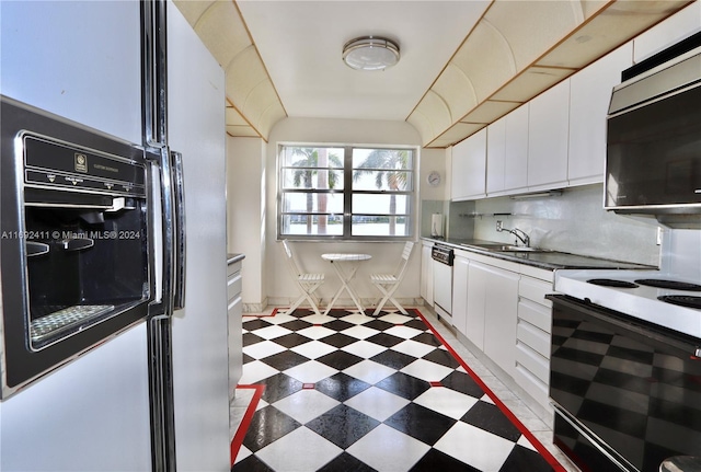 kitchen featuring decorative backsplash, sink, white cabinets, and white appliances