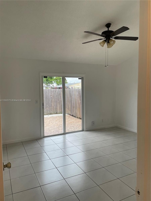 unfurnished room with ceiling fan and light tile patterned floors