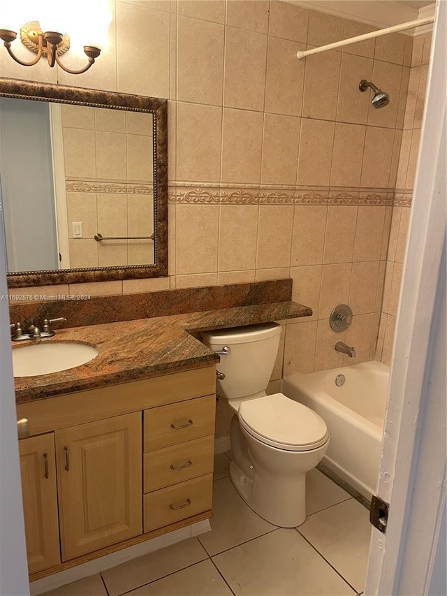 full bathroom featuring tile patterned floors, vanity, tile walls, and toilet