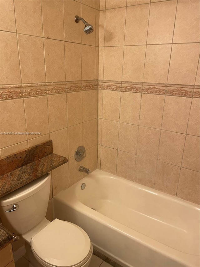 bathroom featuring toilet and tiled shower / bath