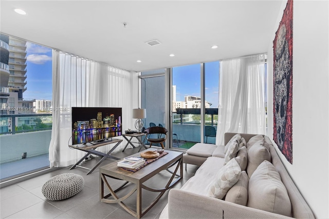 living room featuring a water view and floor to ceiling windows