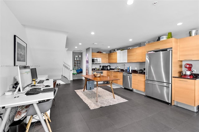 kitchen featuring light brown cabinetry and appliances with stainless steel finishes