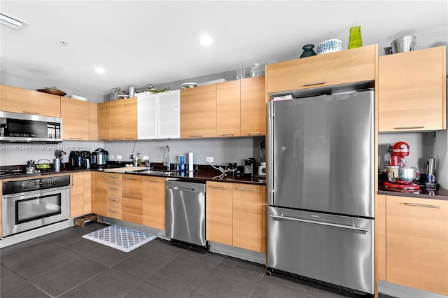 kitchen featuring light brown cabinets, stainless steel appliances, and sink