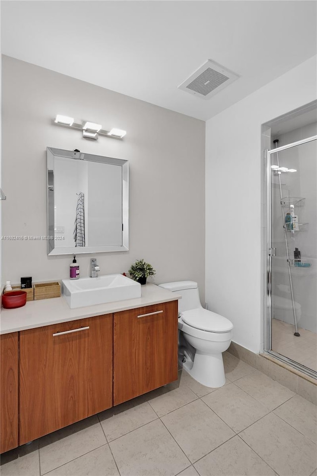 bathroom with toilet, an enclosed shower, vanity, and tile patterned flooring