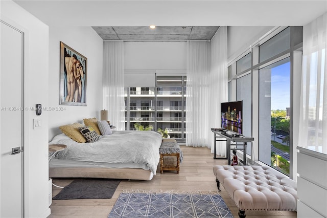 bedroom featuring wood-type flooring and multiple windows