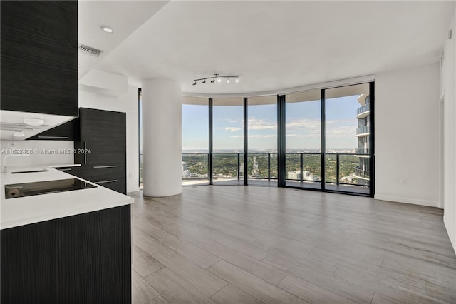 45 SW 9th St Unit 4306, Miami, FL 33130 - unfurnished living room featuring floor to ceiling windows and light wood finished floors