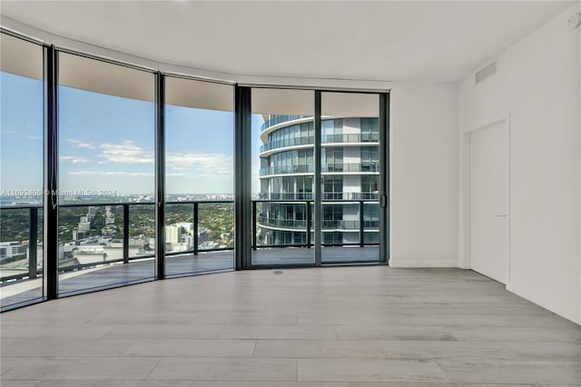 45 SW 9th St Unit 4306, Miami, FL 33130 - spare room featuring expansive windows, wood finished floors, and a view of city