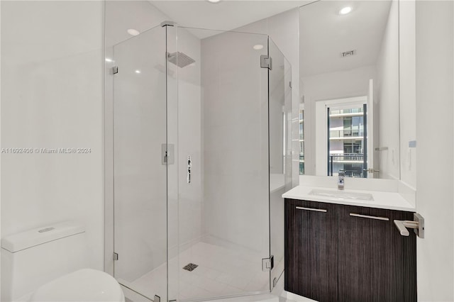 bathroom with vanity, toilet, and an enclosed shower