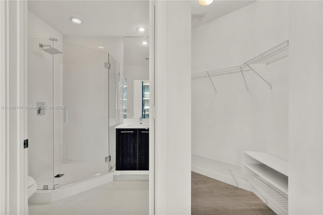 45 SW 9th St Unit 4306, Miami, FL 33130 - bathroom with a shower stall, a walk in closet, vanity, recessed lighting, and toilet