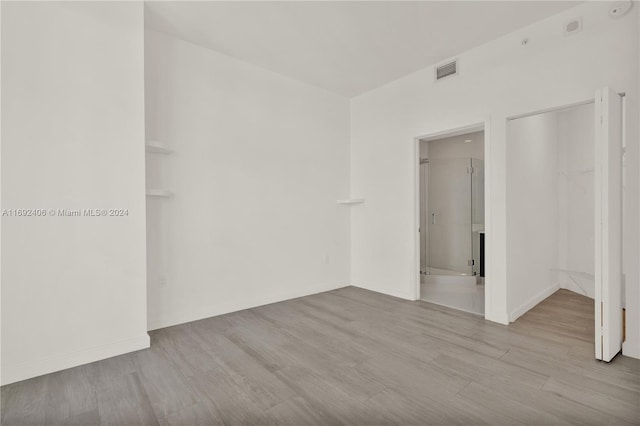 unfurnished room featuring light hardwood / wood-style floors