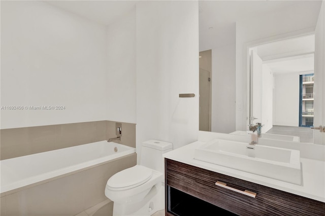 bathroom featuring vanity, a bathing tub, and toilet