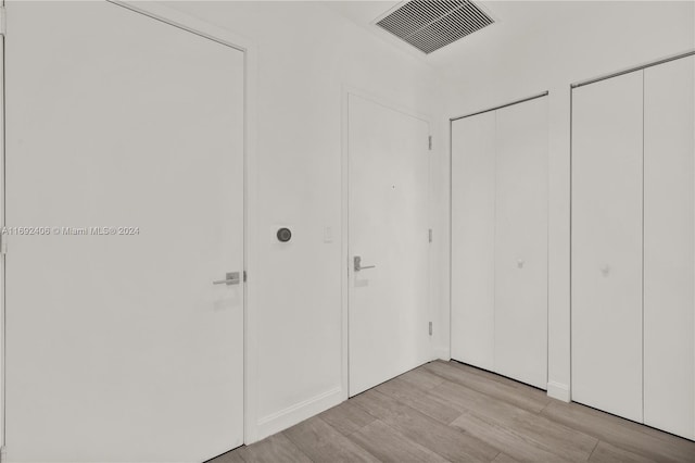 45 SW 9th St Unit 4306, Miami, FL 33130 - unfurnished bedroom with light wood-type flooring, two closets, and baseboards