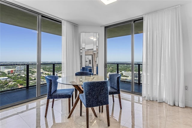 dining space with plenty of natural light, light tile patterned floors, and floor to ceiling windows