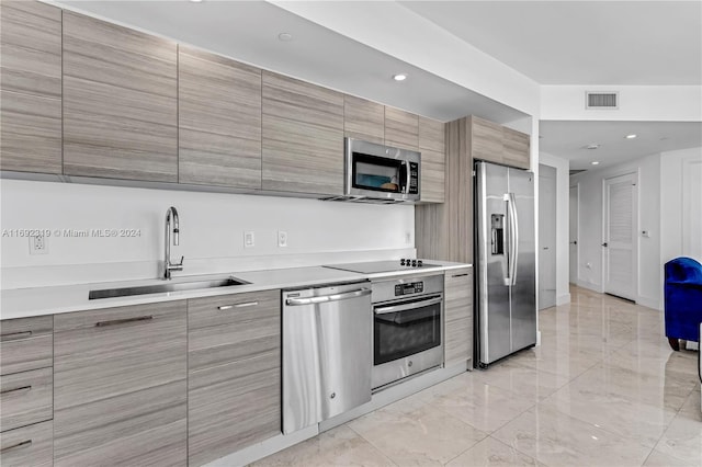 121 NE 34th St Unit 3116, Miami, FL 33137 - kitchen with appliances with stainless steel finishes, a sink, modern cabinets, light countertops, and recessed lighting