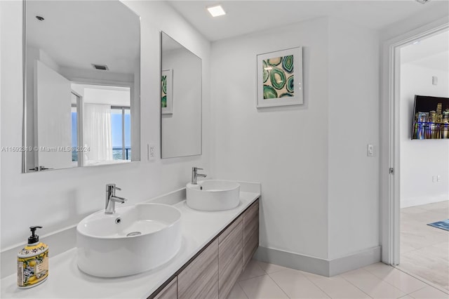 121 NE 34th St Unit 3116, Miami, FL 33137 - full bathroom with double vanity, tile patterned floors, and baseboards