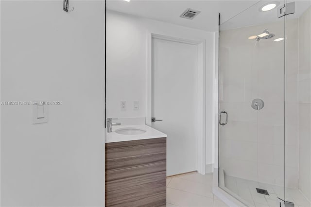 bathroom with vanity, tile patterned floors, and a shower with door