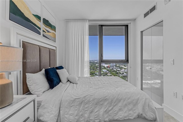 121 NE 34th St Unit 3116, Miami, FL 33137 - bedroom with baseboards and access to outside