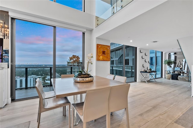 dining room featuring expansive windows and light hardwood / wood-style floors