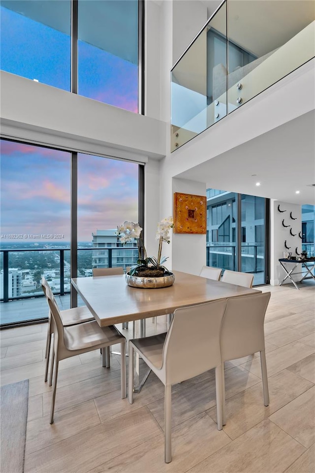 dining area featuring a healthy amount of sunlight and a high ceiling