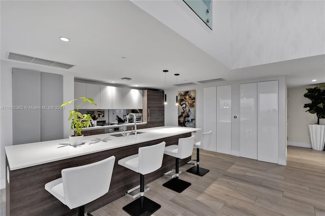 dining room with light hardwood / wood-style floors and sink