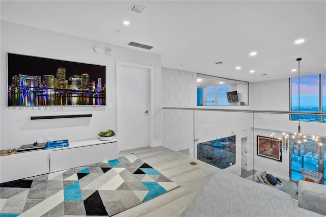 living room featuring a chandelier and hardwood / wood-style flooring