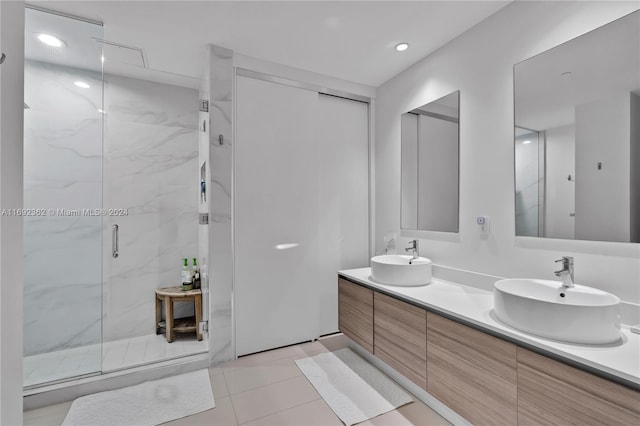 bathroom with vanity, a shower with door, and tile patterned flooring