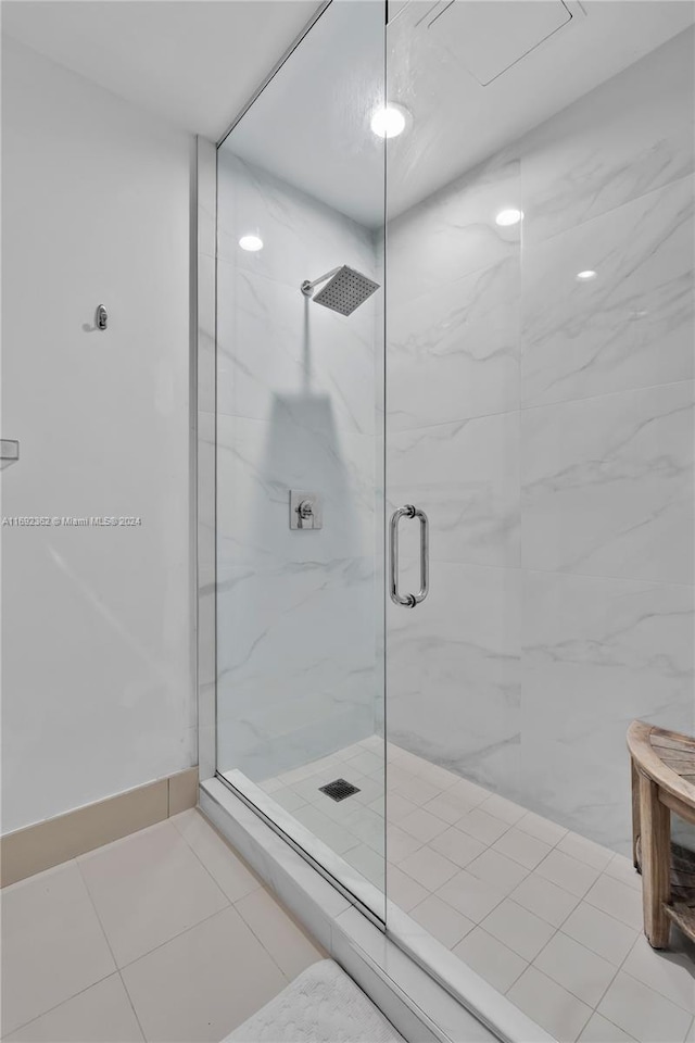 bathroom featuring a shower with door and tile patterned flooring